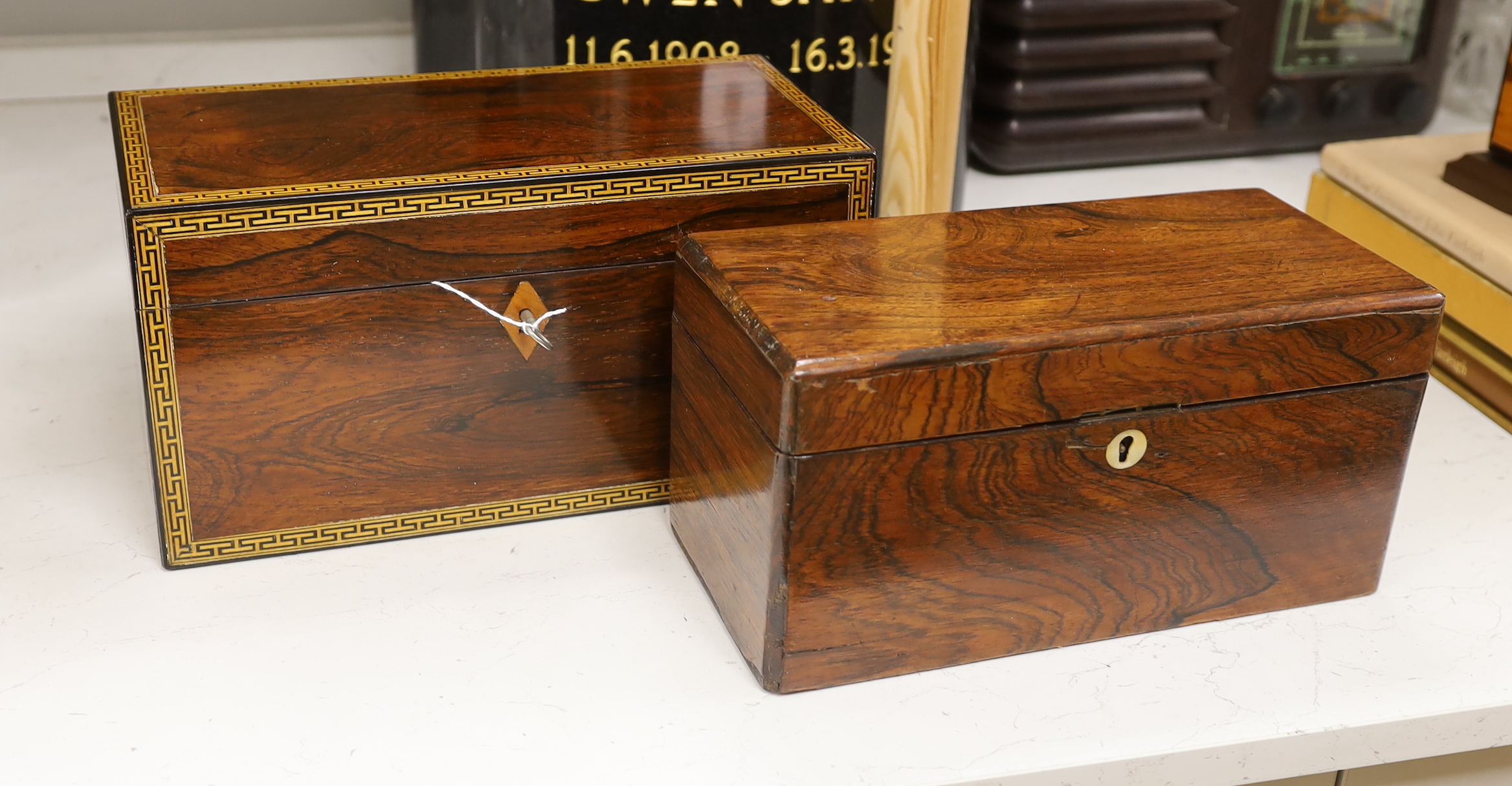 A Victorian rosewood tea caddy with ornate stringing and fitted interior and a mahogany tea caddy, interior missing, rosewood caddy 32.5cm wide, 17cm high